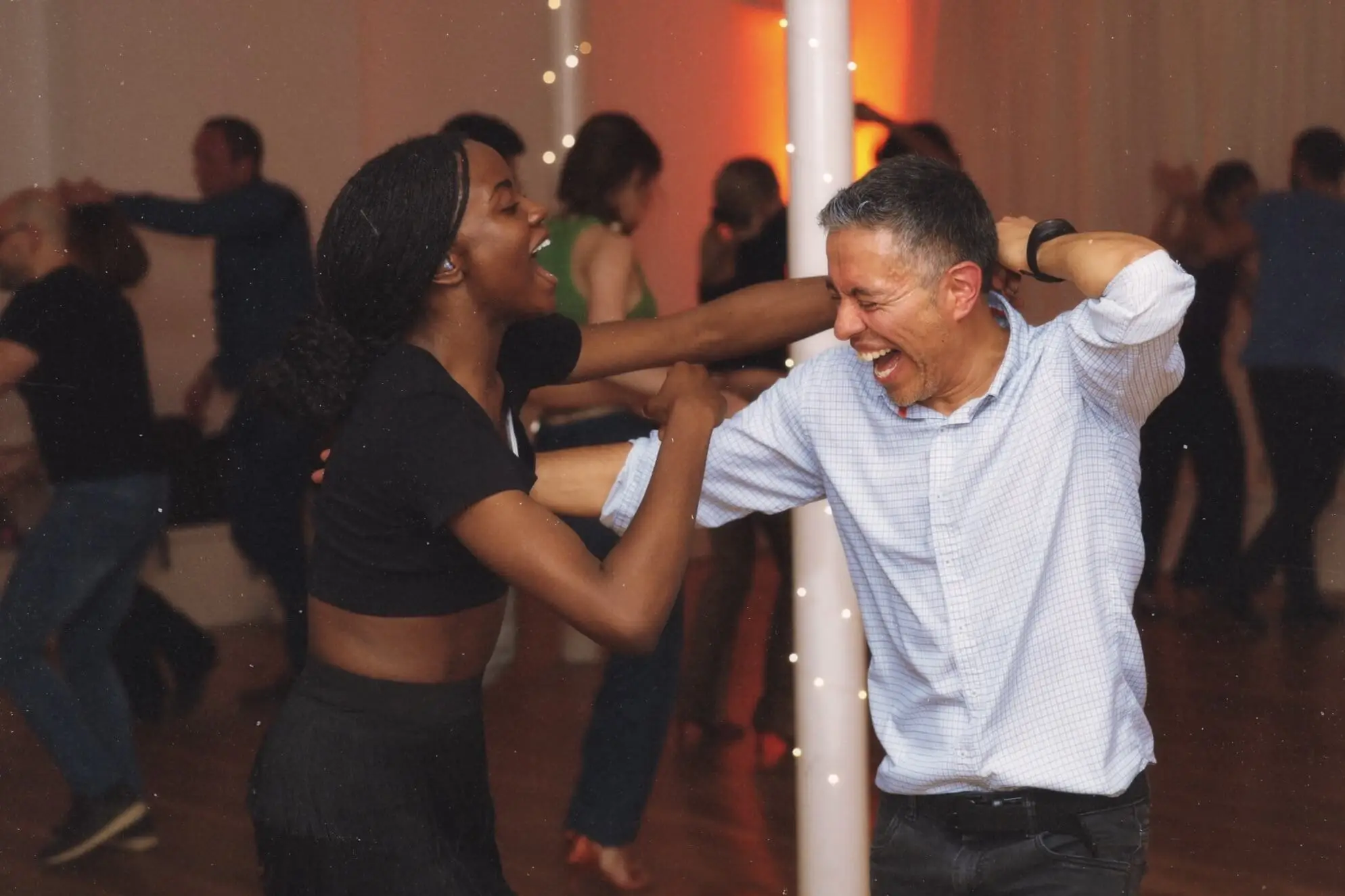 Couple laughing at Changó salsa social night